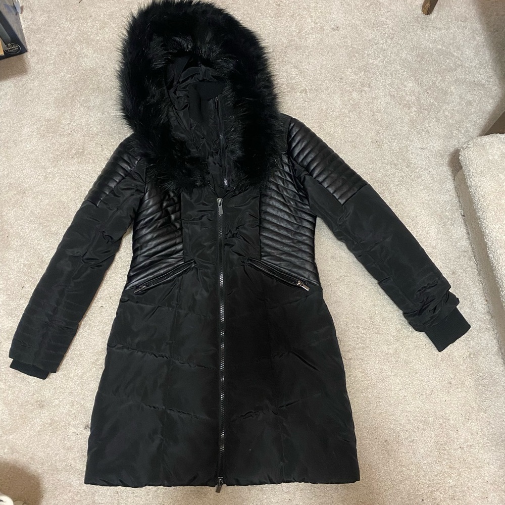 Black winter jacket with leather like accents and furry hood
